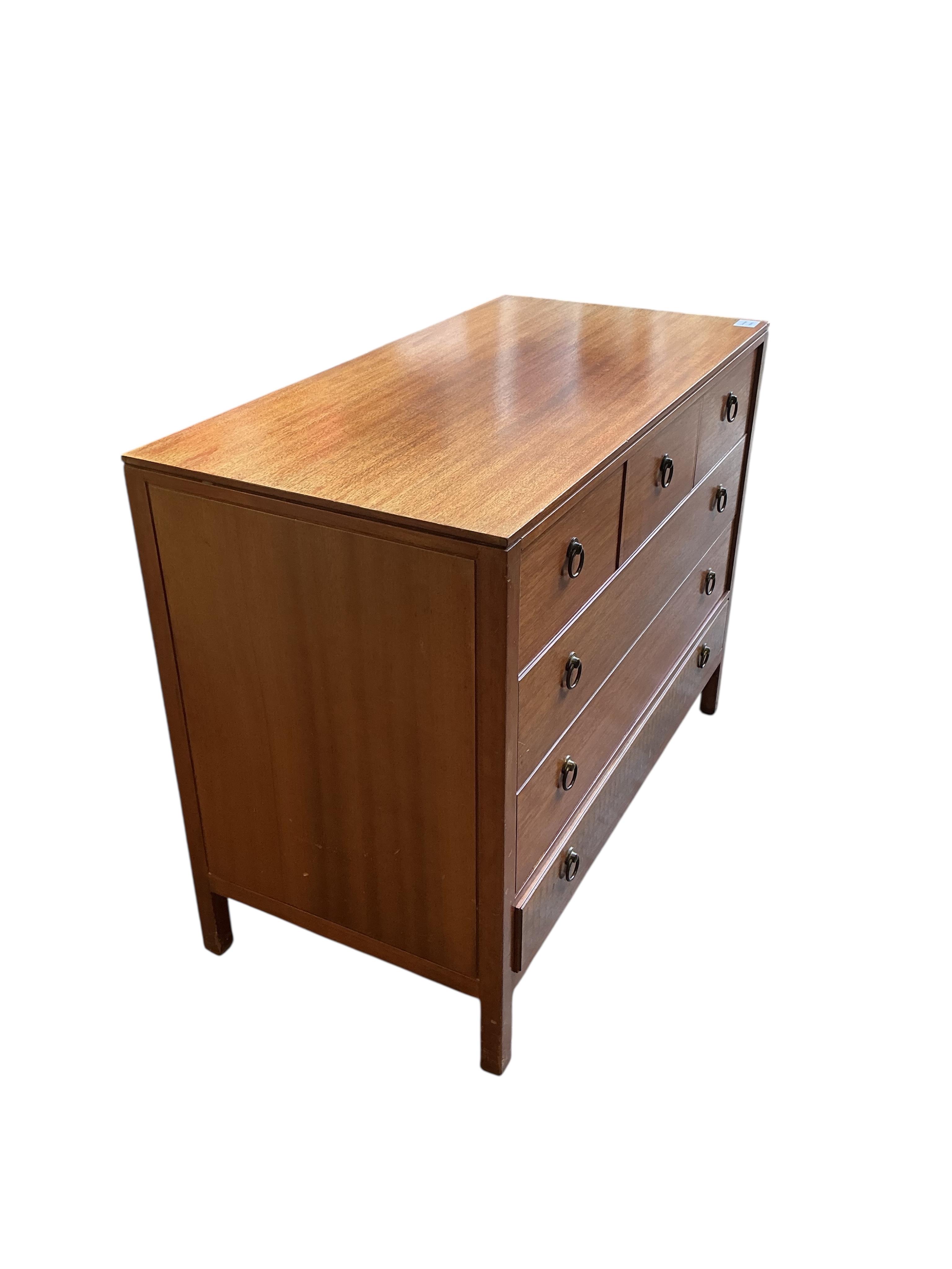 A Loughborough For Heals brass inlaid teak four piece bedroom suite comprising: triple wardrobe, width 120cm, depth 54cm, height 176cm, two chests of drawers and a toilet mirror